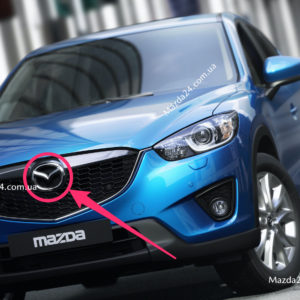 KD4551741 - Эмблема решетки радиатора Mazda CX-5, CX-9